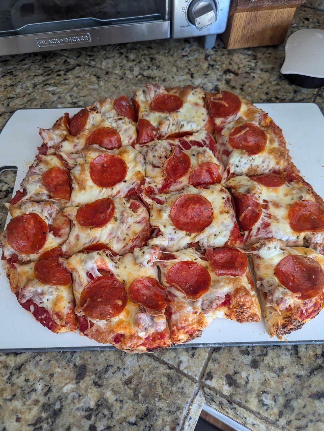Finished pepperoni and sausage pizza cut into squares, Hup's-style